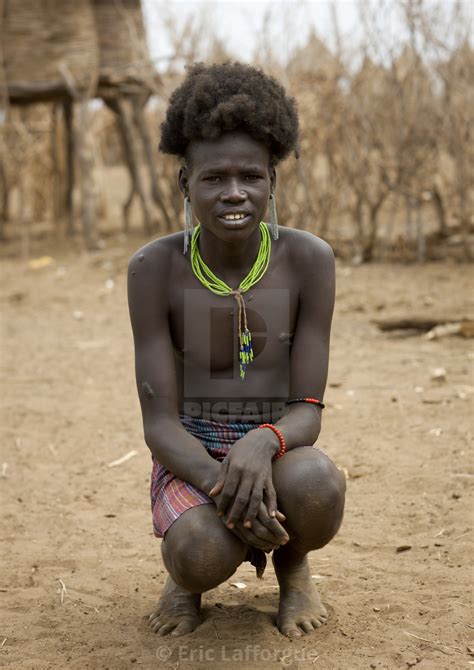 Hairy Squatting Dassanech Teenage Boy Portrait Omorate Ethiopia