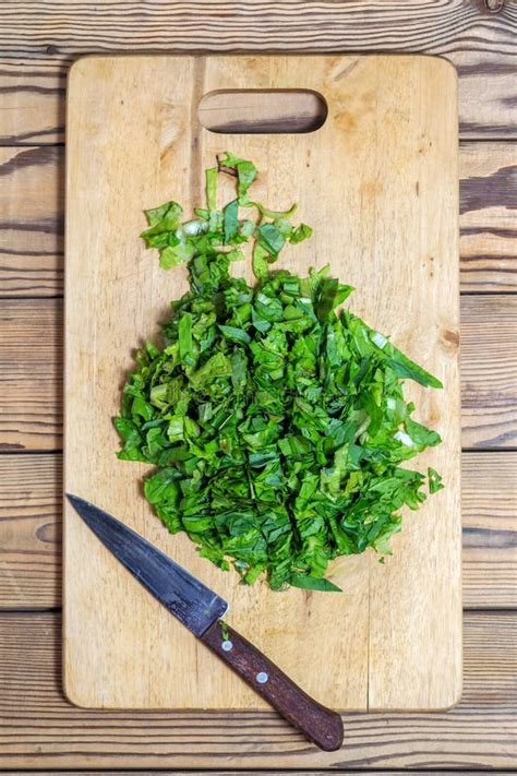 Chopped Spinach Lettuce Parsley On Cutting Board With Knife Stock
