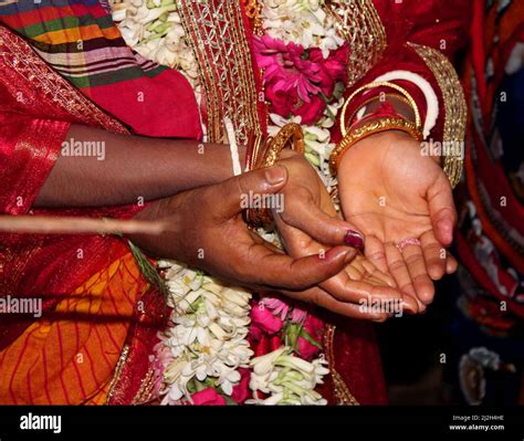 traditional bengali hindu wedding ceremony groom holding hand in bride hand selective focus