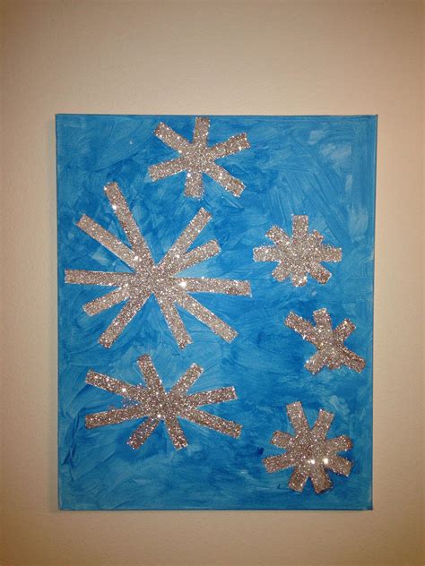 A Blue Painting With Silver Glitter Snowflakes On It