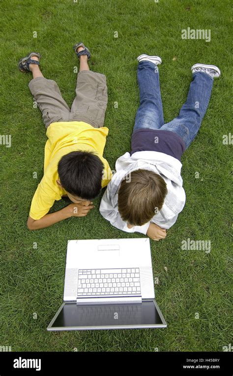 Boys Two Turfs Lie Play Laptop From Above Model Released People