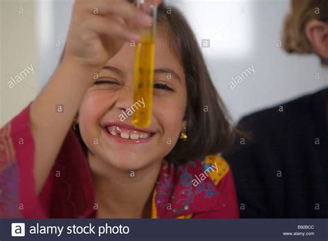 Young Girl Looking At A Test Tube In A Chemistry Science