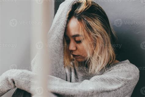 Depressed And Sad Young Woman Sitting Alone At Home 7196911 Stock Photo