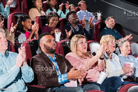 Multiethnic Audience In Movie Theater Clapping Stock Photo Download