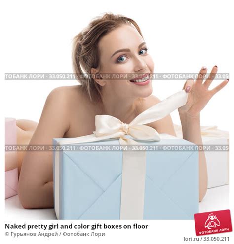 Naked pretty girl and color gift boxes on floor Стоковое фото