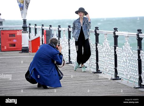 A Photographer Photographing Attractive Young Female Model Wearing