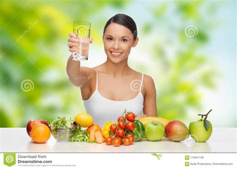 Woman With Healthy Food On Table Drinking Water Stock