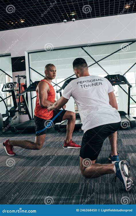 Back View Of Personal Trainer Instructing Stock Photo Image Of