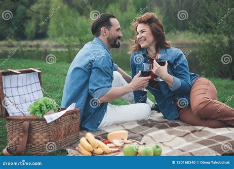 Cheerful Husband And Wife Having Picnic Near Water Stock Photo Image