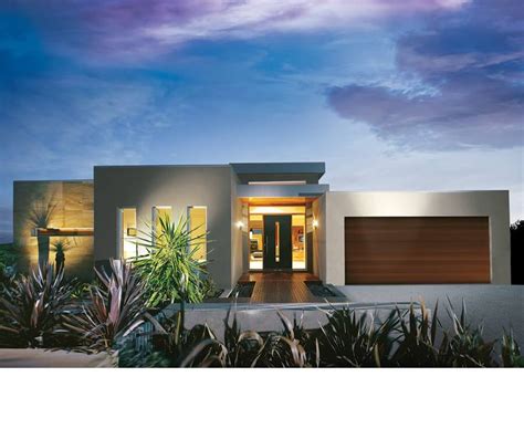 A Modern House Is Lit Up At Night With Palm Trees In The Foreground And