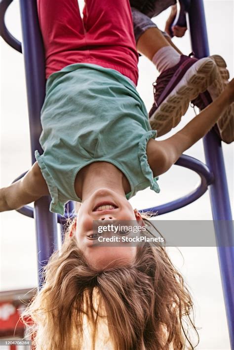 Girl Upside Down At Playground High Res Stock Photo Getty Images