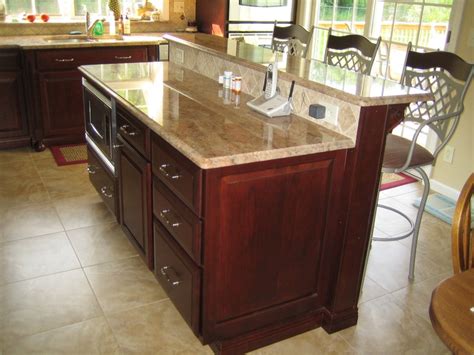 Traditionally, kitchen cabinets are mounted on walls. Island with granite countertop, overhang and stools | Home ...