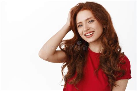 Portrait Of Beautiful Natural Redhead Girl With Curly Hair Touching
