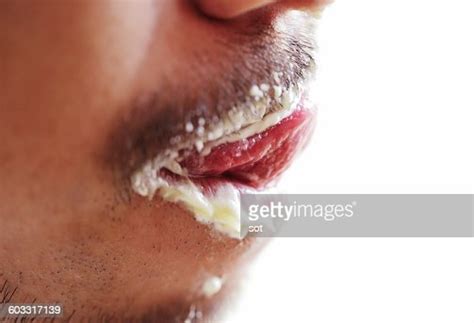 Young Man Licking With Cream In Mouthclose Up Photo Getty Images