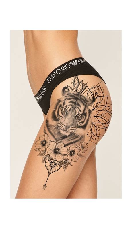 A Woman S Thigh With A Tiger Tattoo On The Side And Flowers Around It