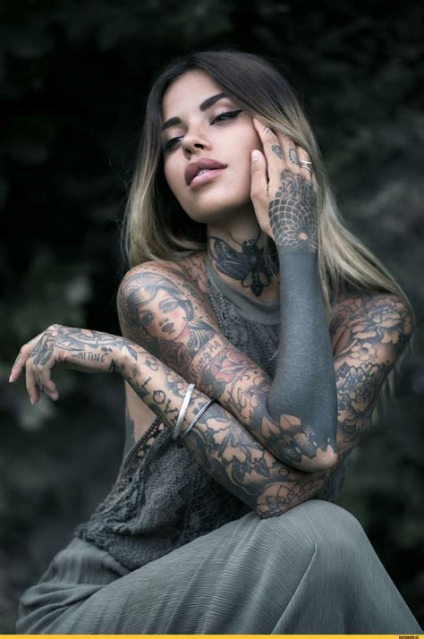 A Woman With Tattoos On Her Body And Arm