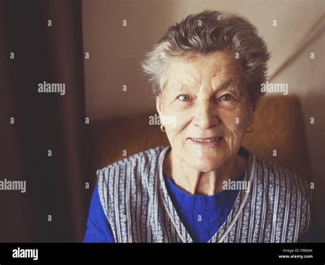 Portrait Of Senior Woman Sitting In Armchair At Home Stock Photo Alamy