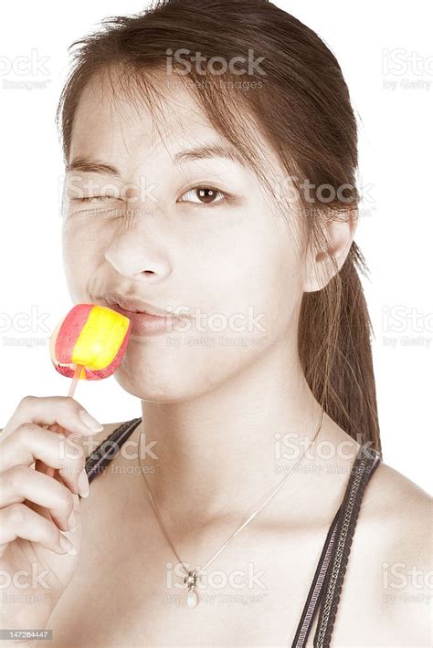 Young Asian Chinese Woman With Lollypop Winking Stock Photo Download