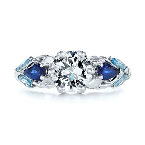 This exquisite engagement ring features a vibrant oval shaped aquamarine weighing 2.07ct set in an open back, four claw setting. Custom Aquamarine Blue Sapphire And Diamond Engagement ...