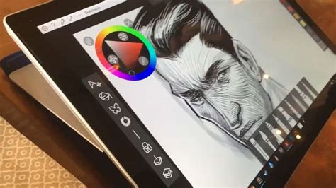A helpful strategy is to draw there are two versions, pro and ex. Artist drawing on a Surface Pro in a bar makes an ...
