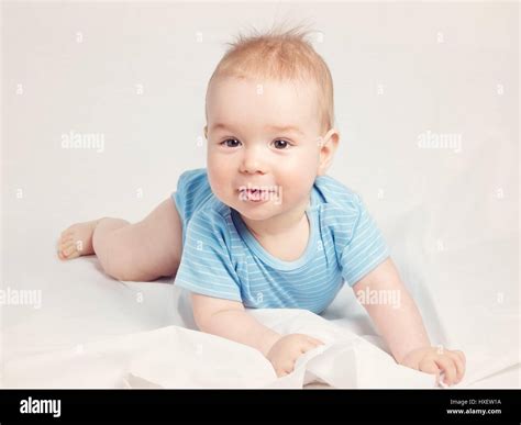 Eight Month Old Baby Lying In The Bed On White Sheet Stock Photo Alamy