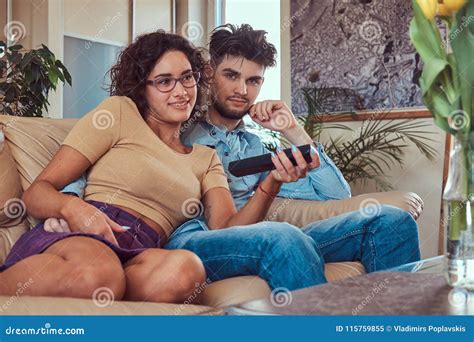 Young Couple Cuddling While Watching Tv At Home Stock Image Image Of