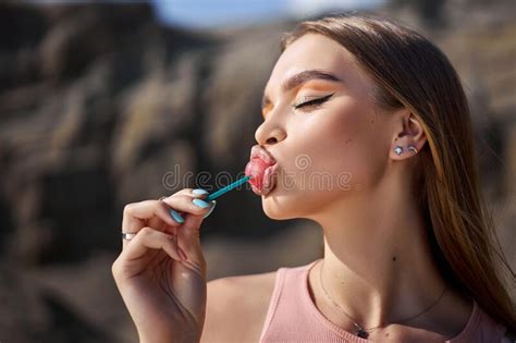 Beautiful Woman Licking A Lollipop Close Up Red Shadows On The Eyes Of A Girl Professional