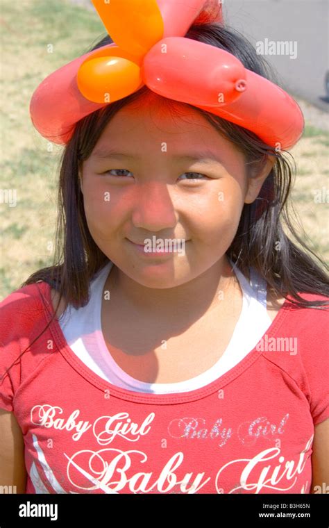 Happy Asian American Girl Age 8 Wearing A Balloon Twist Hat Dragon Festival Lake Phalen Park St