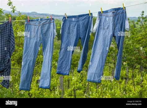 the washed jeans hang on a clothesline pockets turned inside out drying clothes on the street