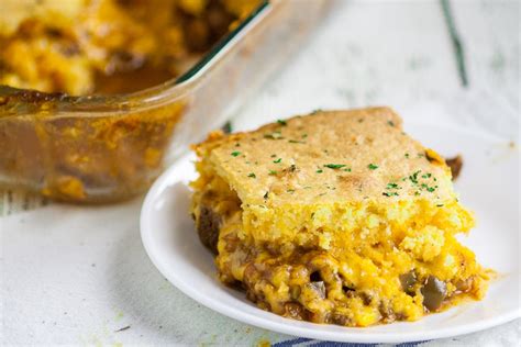 Add the taco seasoning, cheese, rotel (undrained), pinto beans (undrained), and corn (drained) to the ground beef. Cornbread Taco Casserole Recipe | The Gracious Wife