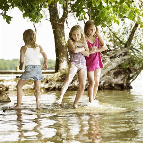Smiling Girls Playing In Lake Stock Image F0044958 Science Photo Library