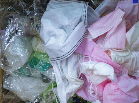 Used Sanitary Napkins Surgical Face Mask And Plastic In The Trash