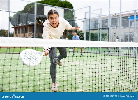 Emotional Young European Girl Padel Player Hitting Ball With Racket On