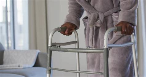 Mid Section Of Senior Man Using Zimmer Frame To Walk At Home Stock Footage