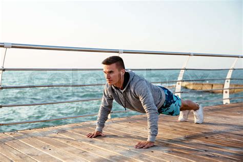 Handsome Sportsman Doing Push Ups Exercises On Pier Stock Image