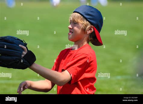 Young Boy Catching A Baseball Wearing Hat Backwards Stock Photo Alamy