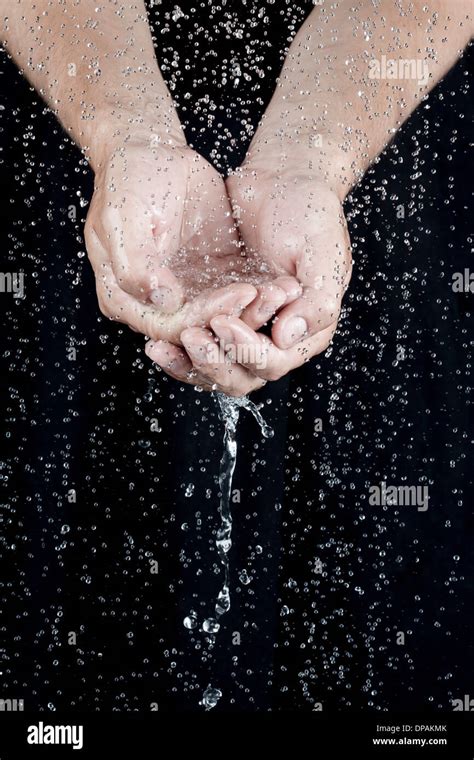 Cupped Hands Holding Water With Droplets Stock Photo Alamy