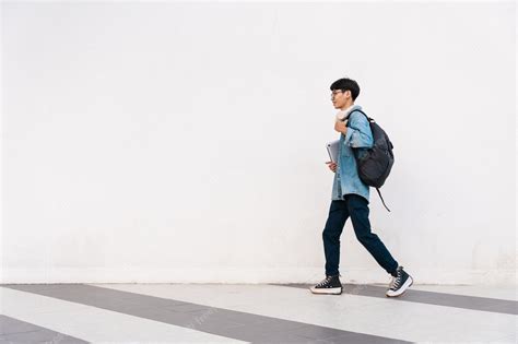 Premium Photo Portrait Of Asian Male Student Walking Isolated On