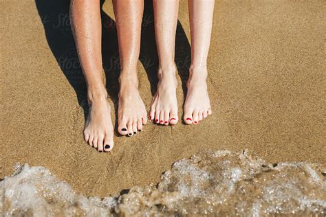 Closeup Of Women Tanning The Legs On The Beach By Bonninstudio