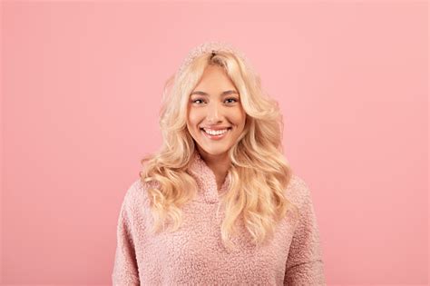 happy person portrait of friendly blonde lady with beautiful smile wearing hoodie and smiling