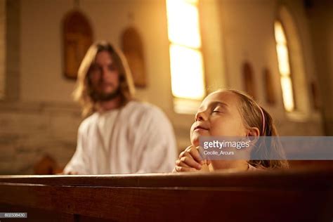 Cropped Shot Of A Little Girl Praying In A Church While