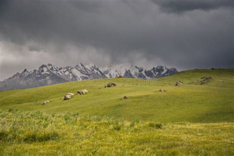 Mountain Peaks With Snow Green Pastures Under Thunderstorm In The At