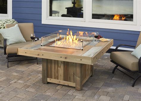This diy gas fire pit is created from a garden patio table so the fire pit is in the center and there is table space all around the perimeter. Gas Fire Pit Tables | Burnsville MN | Wissota Outdoor Living
