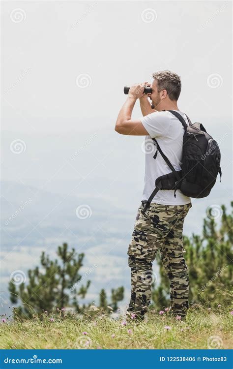 Man Enjoying The Nature And Looking Through Binoculars Stock Photo