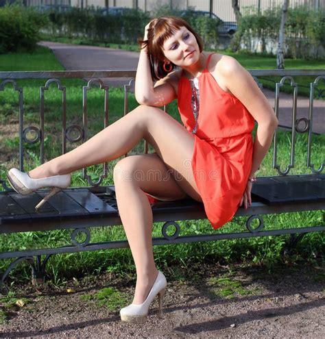 Long Legged Redhead Photomodel In Red Miniskirt And Shiny Stockings