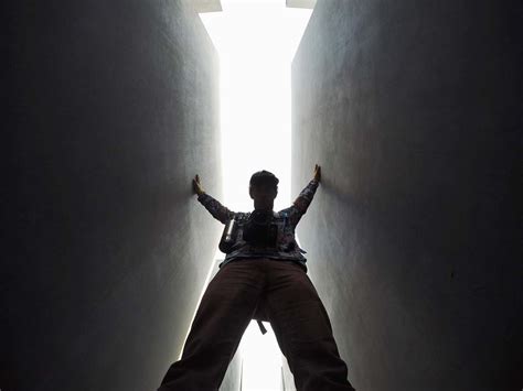 Person Low Angle Photo Of Man Standing Between Walls Lighting Image