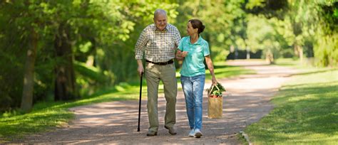 Caregiver Woman Helping Senior Man Outdoors In The Park Behavioral Health Systems Inc