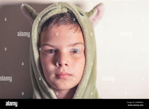 Headshot Portrait Of A 9 Year Old Boy In The Sleeping Gown Standing