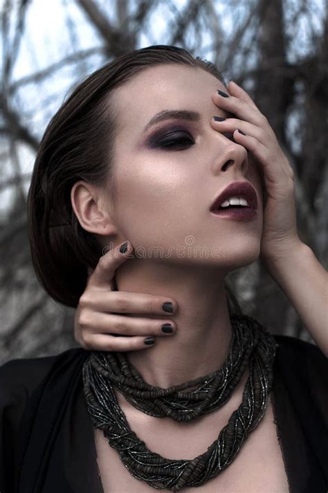 Pretty Brunette Girl With Bright Makeup And Purple Lips Wearing Black