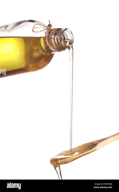 Olive Oil Flowing On Spoon From Bottle Hi Res Stock Photography And